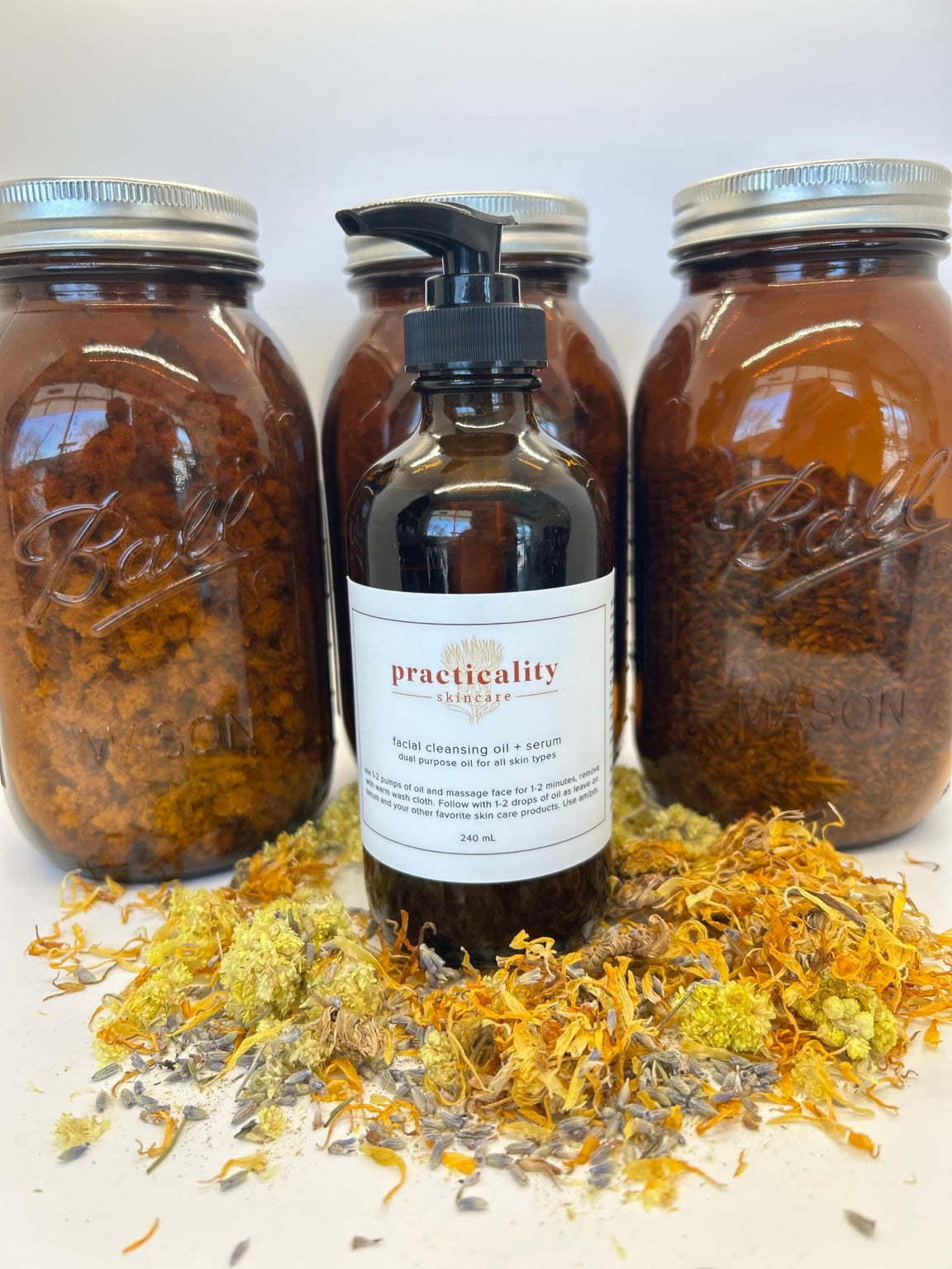 Facial Cleansing Oil + Serum 8 oz bottle displayed with calendula and other dried botanicals